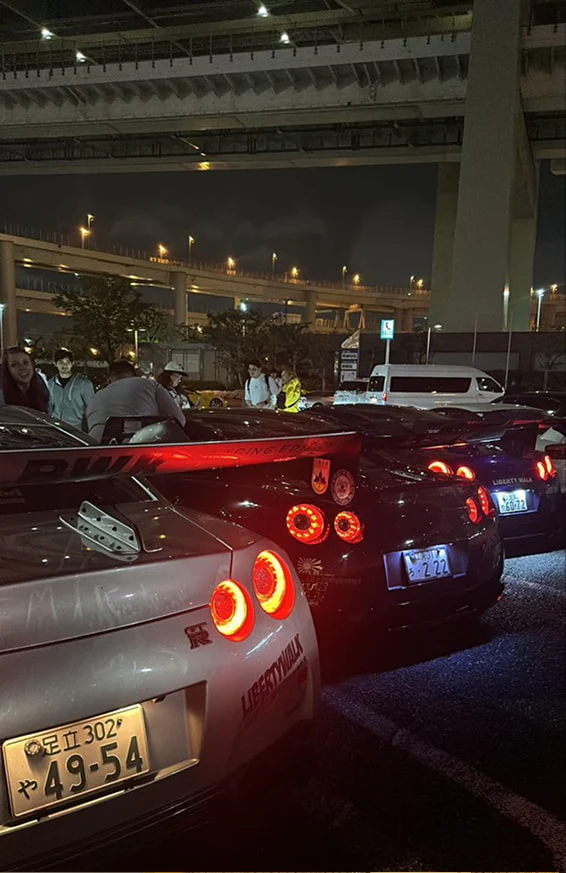 Tail lights of parked cars at night